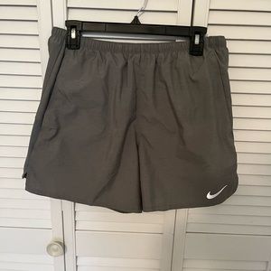 Women’s Nike running shorts with pockets & snap pocket at back waist. NWOT. Med.